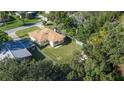 Aerial view of a yellow house with a large backyard and detached shed at 402 Tuscarora St, Lakeland, FL 33805