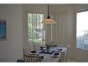 Bright dining room with table set for four and window views at 608 Copeland Dr, Haines City, FL 33844