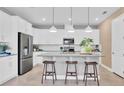 Modern kitchen with white cabinets, gray countertops, and island at 3896 Deer Ridge Dr, Mount Dora, FL 32757