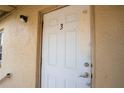 White door with number 3 on a tan building at 725 Michigan Ct # 3, St Cloud, FL 34769