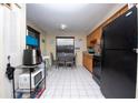 Small kitchen with black appliances and dining area at 725 Michigan Ct # 3, St Cloud, FL 34769