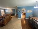 Spacious living room features hardwood floors and a view into the kitchen at 1615 Martinsville Ct, Orlando, FL 32825