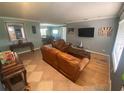 Living room with leather couches and wood floors at 1615 Martinsville Ct, Orlando, FL 32825