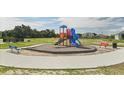 Community playground with playset and benches at 183 Bull Frog Ln, Umatilla, FL 32784
