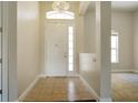 Bright entryway with tile flooring and chandelier at 3757 Eagle Isle Cir, Kissimmee, FL 34746