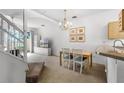 Dining area with chandelier and adjacent kitchen at 1256 S Beach Cir, Kissimmee, FL 34746