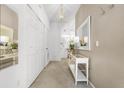 Bright entryway with coat closet and a console table at 1256 S Beach Cir, Kissimmee, FL 34746