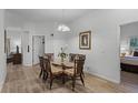 Bright dining room with glass table, wicker chairs, and hardwood floors at 306 Lucaya Loop # B5/U306, Davenport, FL 33897