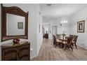 Bright dining room featuring a glass-top table, wicker chairs, and hardwood floors at 306 Lucaya Loop # B5/U306, Davenport, FL 33897