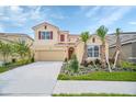 Two-story house with attached garage and landscaping at 7535 Oakmoss Loop, Davenport, FL 33837