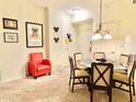 Round glass dining table with six chairs, red accent chair at 8112 Poinciana Blvd # 1301, Orlando, FL 32821