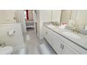 Shared bathroom with double vanity and a view of a bedroom at 1676 Moon Valley Dr, Davenport, FL 33896