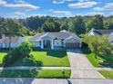 House with a gray exterior and a large green lawn at 5232 Deer Creek Dr, Orlando, FL 32821