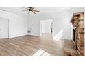 Living room with hardwood floors, fireplace, and ceiling fan at 751 Avenue B Sw, Winter Haven, FL 33880