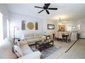 Open living room and dining area with light beige couch and table at 4734 Vero Beach Pl, Kissimmee, FL 34746
