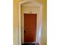 Orange front door with a tiled entryway at 6265 Contessa Dr # 101, Orlando, FL 32829