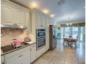 Kitchen features granite countertops, ample cabinetry, and breakfast nook at 1049 Lake Berkley Dr, Kissimmee, FL 34746