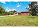 Brick home with a large yard and driveway at 7819 Puritan Rd, Orlando, FL 32807