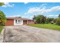 Brick home with a large yard and driveway at 7819 Puritan Rd, Orlando, FL 32807