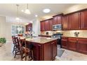Spacious kitchen with an island, granite countertops, and dark wood cabinets at 341 Navarra Ln, Davenport, FL 33837