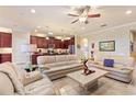 Spacious living room with light beige couches and a large stone coffee table at 341 Navarra Ln, Davenport, FL 33837