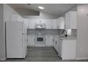 Modern kitchen featuring white cabinets, new appliances, and quartz countertops at 411 Gannet Ct, Kissimmee, FL 34759