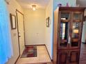 Inviting entryway with tile flooring and a charming display cabinet at 2867 Longleaf Ct, Kissimmee, FL 34746