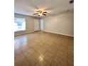 Spacious living room with tile flooring and ceiling fan at 1940 Tripaul Ct, Bartow, FL 33830
