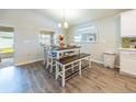 Dining area with table, bench seating, and wood-look floors at 872 Sydney St, Davenport, FL 33837