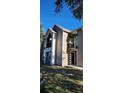 Two-story condo building with balconies and tan colored siding at 4768 Walden Cir # 327, Orlando, FL 32811