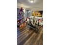 Living room features hardwood floors, a Christmas tree, and white couch at 4768 Walden Cir # 327, Orlando, FL 32811