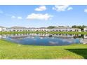 Waterfront view of community with lake reflecting buildings at 4523 Cypress Cay Way, Kissimmee, FL 34746