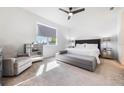 Bright bedroom with king-size bed, gray bench, and mirrored dresser at 2195 Bluebird Pl, St Cloud, FL 34771