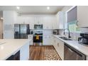 Modern kitchen with white cabinets, stainless steel appliances, and quartz countertops at 2195 Bluebird Pl, St Cloud, FL 34771