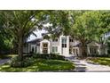 Beautiful home with a large front yard and mature trees at 5126 Fairway Oaks Dr, Windermere, FL 34786