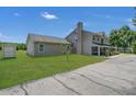 House exterior showcasing a side view, screened porch and yard at 3105 Pastures Rd, Kissimmee, FL 34746