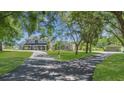 Two-story house with a long driveway and lush landscaping at 3105 Pastures Rd, Kissimmee, FL 34746