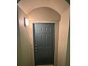 Gray front door with arched entryway and overhead light fixture at 3331 Whitestone Cir # 104, Kissimmee, FL 34741