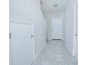 Bright entryway with tile flooring, coat closet, and staircase at 10556 Salt Grove St, Orlando, FL 32824