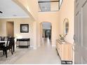 Bright foyer with tile floors, a console table and view to dining room and living areas at 3425 Halsway Dr, Orlando, FL 32824