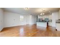 Open concept living room and kitchen with hardwood floors at 14315 Swanley St, Orlando, FL 32832