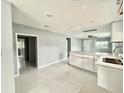 Modern kitchen with white cabinets and marble floors at 7980 Alturas Rd, Bartow, FL 33830