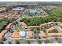 Aerial view of community with pool and surrounding homes at 1129 Park Ridge Cir, Kissimmee, FL 34746