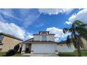 Two-story house with attached garage and palm tree at 3011 Bransbury Ct, Kissimmee, FL 34747
