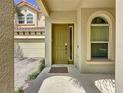 Inviting front door with arched entryway and a welcome mat at 416 Orange Cosmos Blvd, Davenport, FL 33837