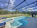 Relaxing pool area with a screened enclosure and spa at 416 Orange Cosmos Blvd, Davenport, FL 33837