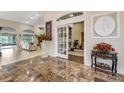 Elegant entryway with marble flooring and views to the living room and library at 62 Coquina Ridge Way, Ormond Beach, FL 32174