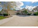 One-story home with a large driveway and lush landscaping at 62 Coquina Ridge Way, Ormond Beach, FL 32174