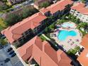 Aerial view of community featuring multiple buildings and pool at 910 Charo Pkwy # 331, Davenport, FL 33897