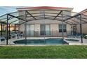 Screened in pool and spa with lounge chairs at 256 Sevilla Ave, Davenport, FL 33897